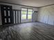 A living room featuring hardwood floors, modern wall accents, and bright light from the window at 496 Tague St, Greenfield, IN 46140