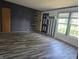 A living room featuring hardwood floors, modern wall accents, and lots of light from the window at 496 Tague St, Greenfield, IN 46140