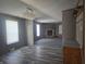 Inviting living room featuring a stone fireplace and attractive wood-look flooring at 496 Tague St, Greenfield, IN 46140