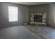Living Room boasts a stone fireplace, bright windows, and updated flooring at 496 Tague St, Greenfield, IN 46140