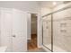 Bathroom with a glass shower door, neutral tile, and a view into the walk-in closet at 4995 S 650 W, Jamestown, IN 46147