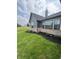 The exterior of a home featuring dark gray siding, brick accents, and professional landscaping at 4995 S 650 W, Jamestown, IN 46147