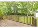 Wooden deck overlooking lush backyard with mature trees and shed at 5104 W Prairiewood Dr, Muncie, IN 47304