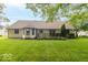 Back of home with back deck and well-manicured backyard at 5104 W Prairiewood Dr, Muncie, IN 47304