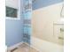 Bathroom featuring a tub and shower combination with patterned blue curtains at 5104 W Prairiewood Dr, Muncie, IN 47304