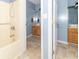 This bathroom features a bath and shower combination and a vanity with a wooden cabinet at 5104 W Prairiewood Dr, Muncie, IN 47304