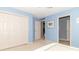 Light blue bedroom featuring carpet floors and a double door closet at 5104 W Prairiewood Dr, Muncie, IN 47304
