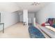 Bonus room featuring carpeted floors, seating, and staircase access at 5104 W Prairiewood Dr, Muncie, IN 47304