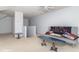 Bonus room features carpeted floors, seating, and staircase at 5104 W Prairiewood Dr, Muncie, IN 47304