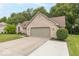 Charming brick home with a well-manicured lawn and an attached two-car garage at 5104 W Prairiewood Dr, Muncie, IN 47304