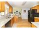Well-lit kitchen featuring wood cabinets, granite countertops, and stainless steel appliances at 5104 W Prairiewood Dr, Muncie, IN 47304