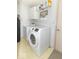 Laundry room with white cabinets, modern washer, and vinyl floors at 5104 W Prairiewood Dr, Muncie, IN 47304