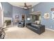 Spacious living room with high ceilings, fireplace, and an open layout to the dining area at 5104 W Prairiewood Dr, Muncie, IN 47304
