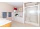 Bright main bathroom features a shower, tub, grey towels, and tile floor at 5104 W Prairiewood Dr, Muncie, IN 47304