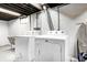 Basement laundry area featuring a washer and dryer with exposed ductwork at 5203 Carrollton Ave, Indianapolis, IN 46220
