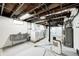Spacious basement area with a laundry sink, washer, dryer, and mechanicals at 5203 Carrollton Ave, Indianapolis, IN 46220