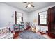 Playful bedroom with hardwood floors, light blue walls, two windows and a tent at 5203 Carrollton Ave, Indianapolis, IN 46220