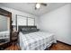 Bedroom features hardwood floors, light walls, a ceiling fan and an updated bed at 5203 Carrollton Ave, Indianapolis, IN 46220