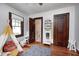Bright bedroom with wooden floors, playroom accessories, and access to the hall bathroom at 5203 Carrollton Ave, Indianapolis, IN 46220