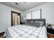 Bedroom features hardwood floors, light walls, ceiling fan and views into attached bath at 5203 Carrollton Ave, Indianapolis, IN 46220