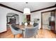 A lovely dining room with dark trim, hardwood floors, a light fixture and views to other rooms at 5203 Carrollton Ave, Indianapolis, IN 46220