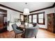 Charming dining room features hardwood floors, trim, large windows and a modern light fixture at 5203 Carrollton Ave, Indianapolis, IN 46220