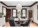 This dining room boasts hardwood floors, dark wood trim and a lovely modern light fixture at 5203 Carrollton Ave, Indianapolis, IN 46220