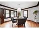 Cozy dining room with hardwood floors, four chairs, and modern lighting fixture at 5203 Carrollton Ave, Indianapolis, IN 46220