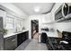 Stylish kitchen featuring stainless steel appliances and black and white cabinets at 5203 Carrollton Ave, Indianapolis, IN 46220