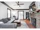 Inviting living room with hardwood floors, brick fireplace, gray sofa, and natural light at 5203 Carrollton Ave, Indianapolis, IN 46220