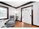 Cozy living room featuring hardwood floors, a gray recliner and abundant natural light at 5203 Carrollton Ave, Indianapolis, IN 46220