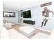 Spacious finished basement featuring a lounge area with comfortable seating and a large-screen TV at 5439 Maywood Dr, Whitestown, IN 46075