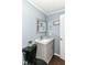 Powder room with a gray vanity, patterned granite countertop, and black toilet at 5439 Maywood Dr, Whitestown, IN 46075