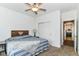 Well-lit bedroom includes a closet with sliding doors, ceiling fan, and comfortable bed for relaxing evenings at 5439 Maywood Dr, Whitestown, IN 46075