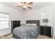 Comfortable bedroom with ceiling fan, bedside tables, and black dressers for a cozy living space at 5439 Maywood Dr, Whitestown, IN 46075