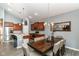Well-lit kitchen and dining area featuring stainless steel appliances, pendant lighting and hardwood floors at 5439 Maywood Dr, Whitestown, IN 46075
