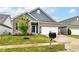 Well-maintained one-story home featuring a gray brick facade, a 2-car garage and lovely landscaping at 5439 Maywood Dr, Whitestown, IN 46075