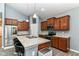 Modern kitchen featuring stainless steel appliances, granite countertops, wooden cabinets and a breakfast bar with seating at 5439 Maywood Dr, Whitestown, IN 46075