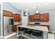 Modern kitchen featuring stainless steel appliances, granite countertops, wooden cabinets and a breakfast bar with seating at 5439 Maywood Dr, Whitestown, IN 46075