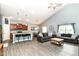 Inviting open-concept living area with vaulted ceilings, neutral walls, laminate floors, and an abundance of natural light at 5439 Maywood Dr, Whitestown, IN 46075