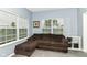 Cozy living room area with a comfortable brown sectional sofa and bright windows at 5439 Maywood Dr, Whitestown, IN 46075