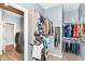 This walk-in closet offers ample storage, featuring rods and shelves for organization near the laundry machines at 5439 Maywood Dr, Whitestown, IN 46075