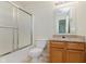 Bright bathroom featuring a granite countertop, a shower/tub combo, and a large mirror at 565 Cembra Dr, Greenwood, IN 46143