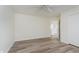 Charming bedroom with wood-look floors and a ceiling fan, offering a view to an open doorway at 565 Cembra Dr, Greenwood, IN 46143