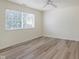 Bright bedroom with wood-look floors, featuring a window for natural light and ample space at 565 Cembra Dr, Greenwood, IN 46143