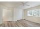 Comfortable bedroom with wood-look floors, offering a ceiling fan, a closet, and natural light at 565 Cembra Dr, Greenwood, IN 46143