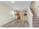 Bright dining area with stairs, kitchen, modern flooring, and natural light at 565 Cembra Dr, Greenwood, IN 46143