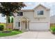 Charming two-story home with a well-manicured lawn, attached two-car garage and inviting front porch at 565 Cembra Dr, Greenwood, IN 46143