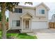 Charming two-story home with a well-manicured lawn, attached two-car garage and inviting front porch at 565 Cembra Dr, Greenwood, IN 46143