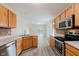 Well-lit kitchen with stainless steel appliances, ample counter space and view of the living area at 565 Cembra Dr, Greenwood, IN 46143